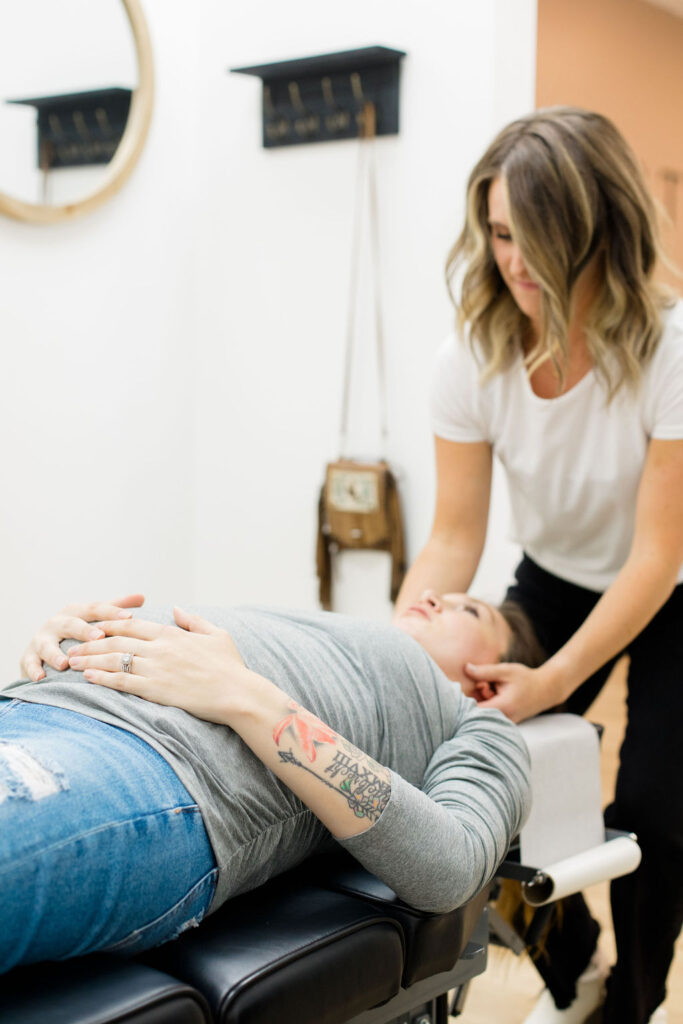 A patient receiving prenatal chiropractic care to alleviate pain. 