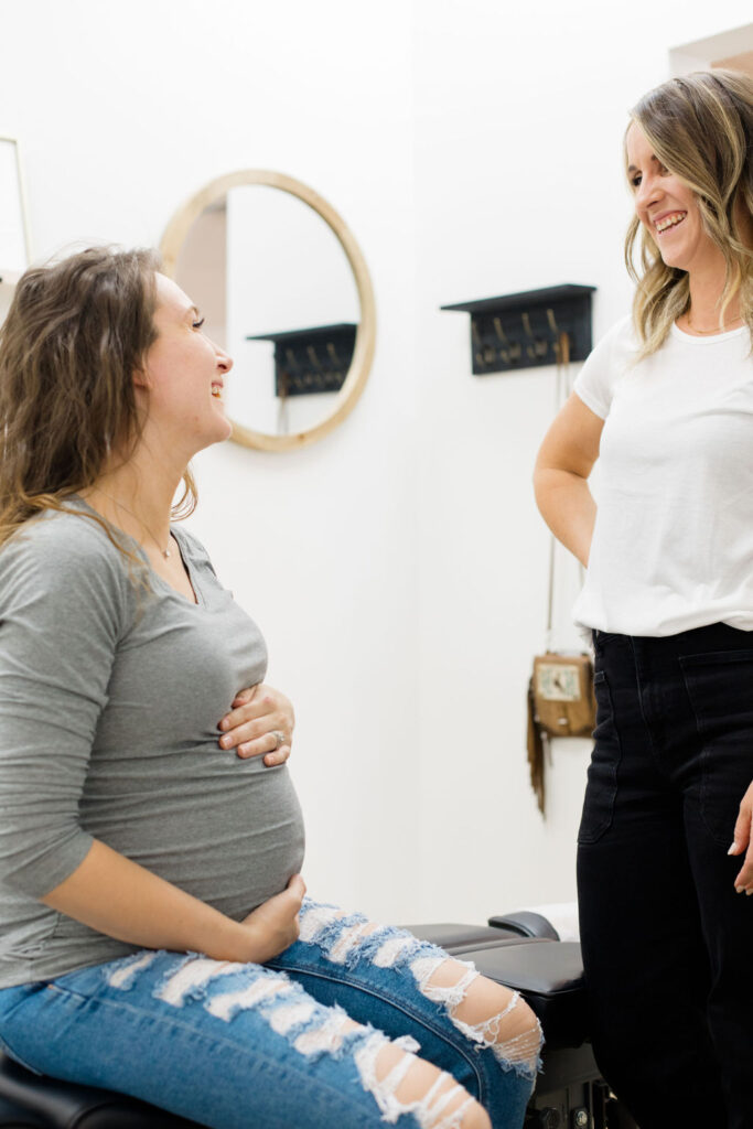 Prenatal Chiropractor talking with a patient. 
