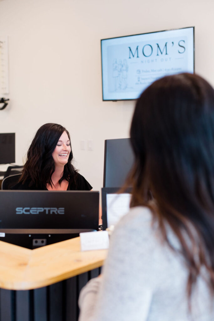 patient checking into impact chiropractic 