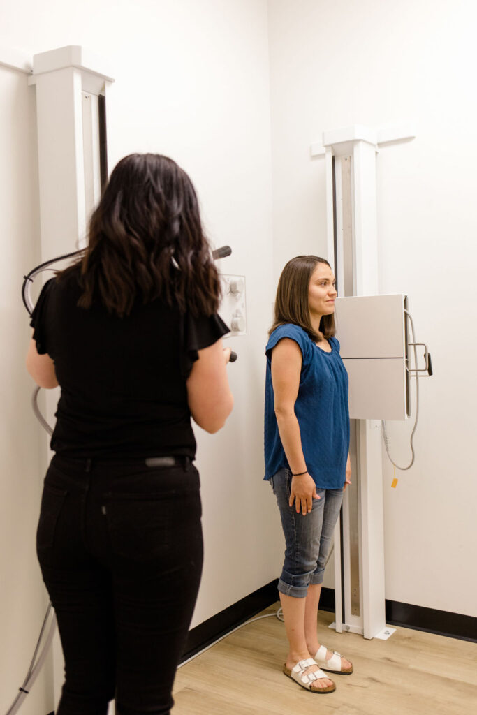 a chiropractor with a patient getting evaluated for spinal stenosis