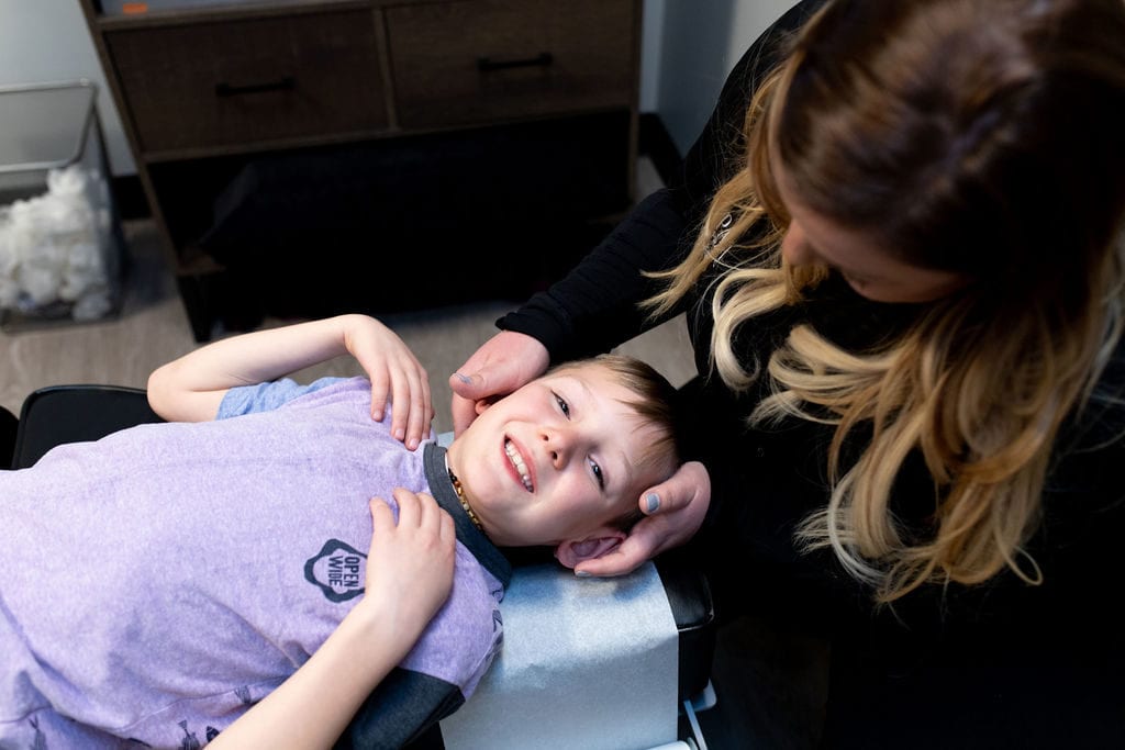 child getting chiropractic adjustment to boost immune system and prevent coronavirus