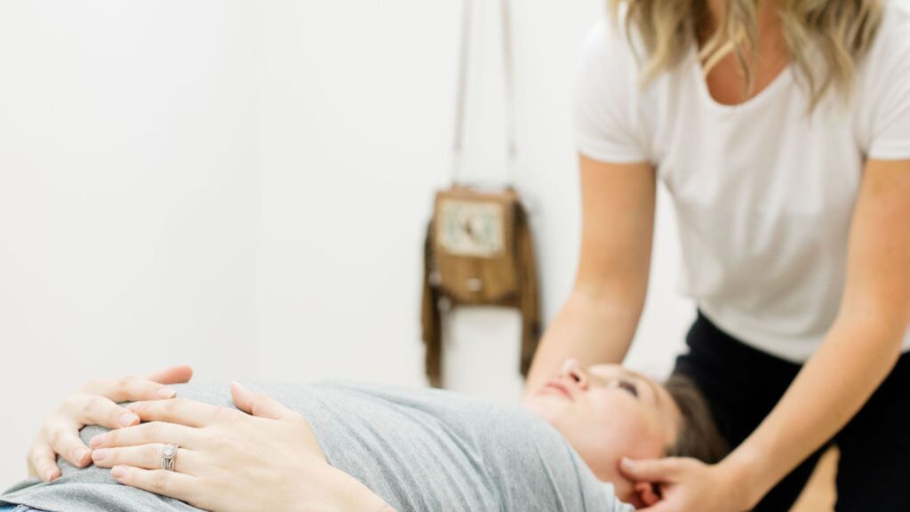 A prenatal chiropractor working with a patient at Impact Chiropractic. 