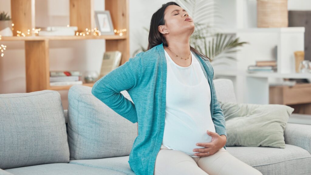 a woman dealing with pregnancy pain 
